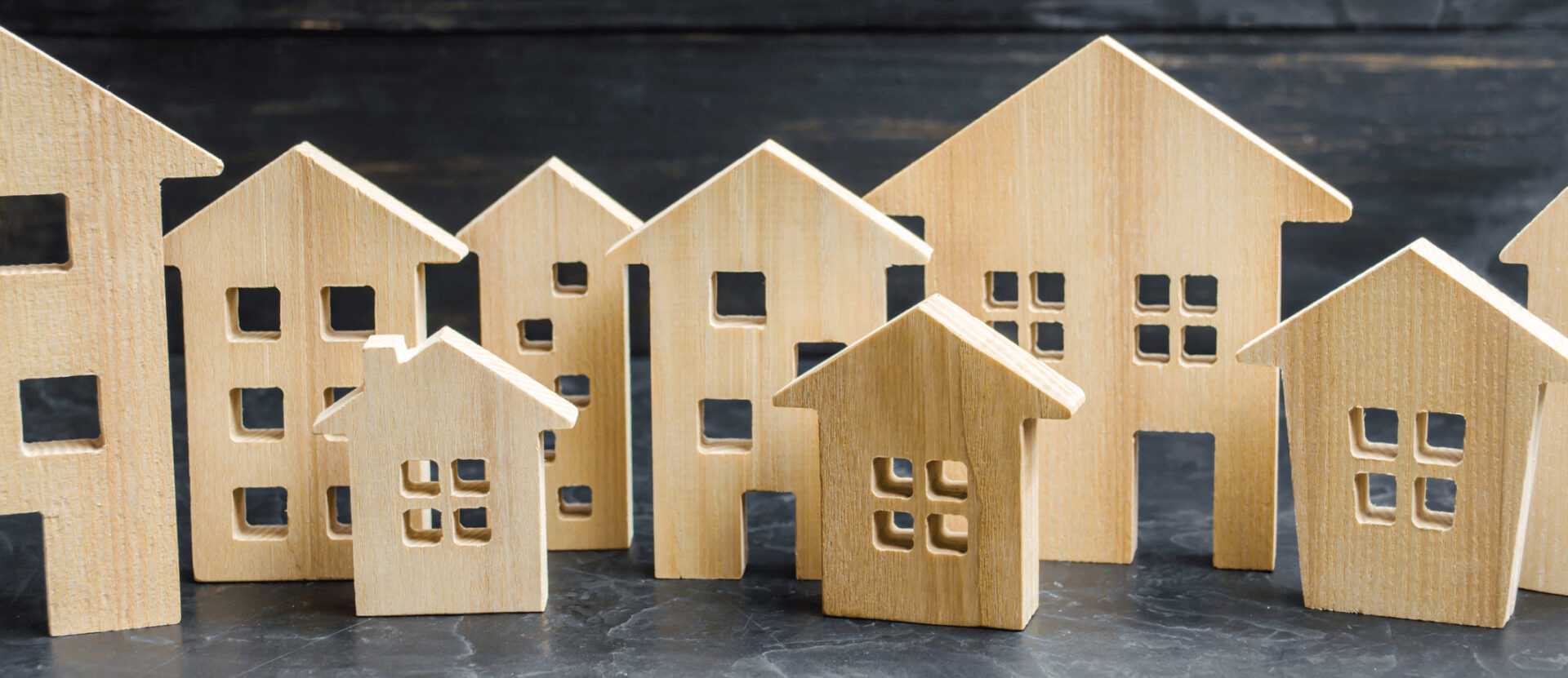 This image shows a row of wooden houses and buildings meant to represent a community of residences.