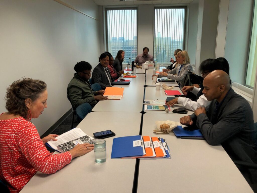 CSH team members with representatives from Detroit and Michigan sitting at a table and discussing