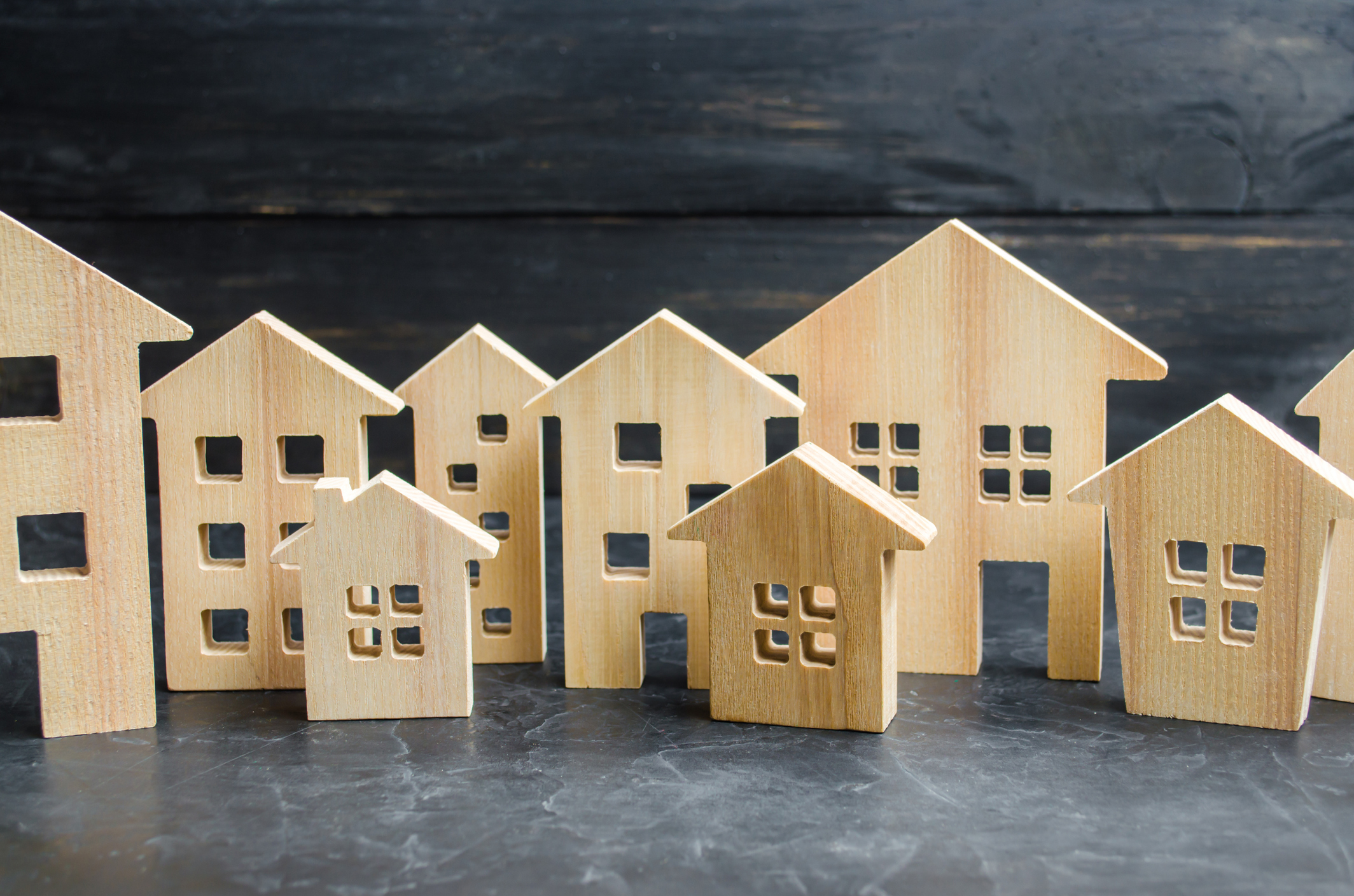 Wooden city and houses. concept of rising prices for housing or rent. Growing demand for housing and real estate. The growth of the city and its population. Investments. agglomeration and urbanization