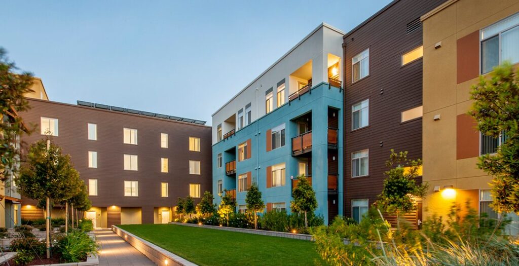 This is a stock image of a modern residential building and landscaped grounds.