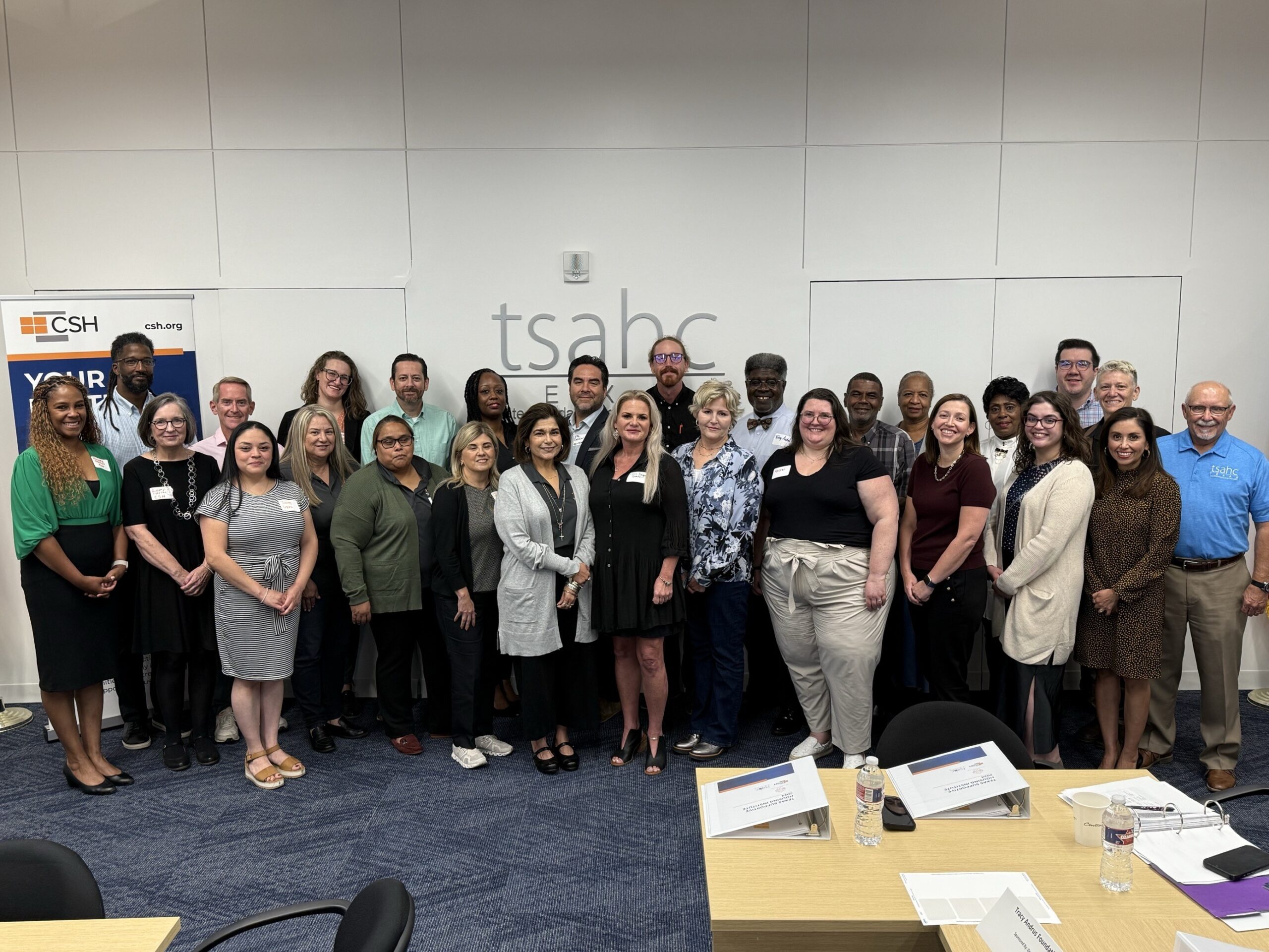 The Texas SHI 2024 teams and CSH staff in front of the TSAHC logo