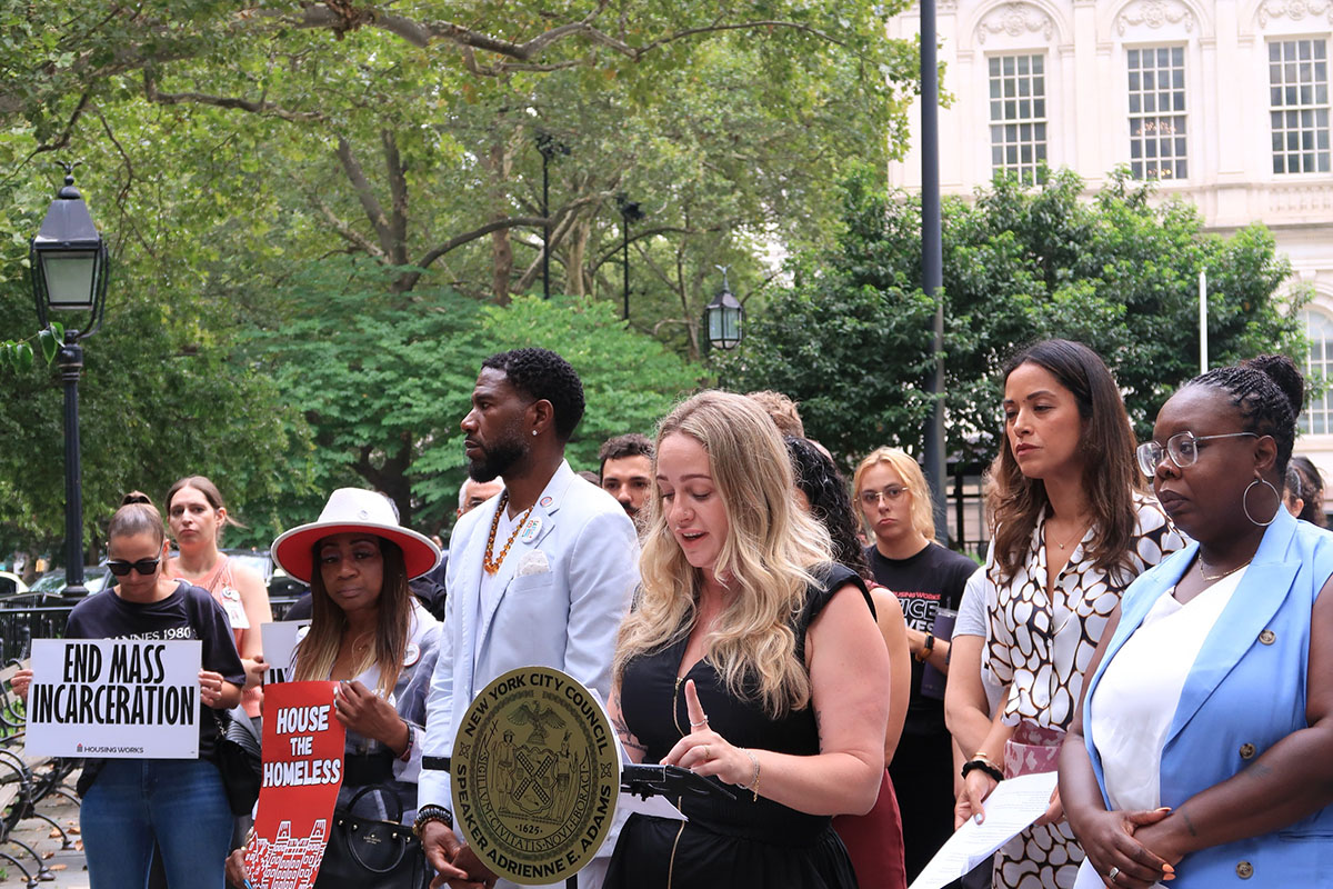 A photo of CSH's Metro Team director speaking at a press conference in front of NYC City Hall.