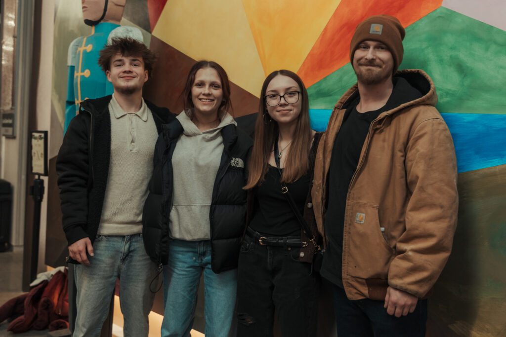 group of people standing next to each other smiling at the camera