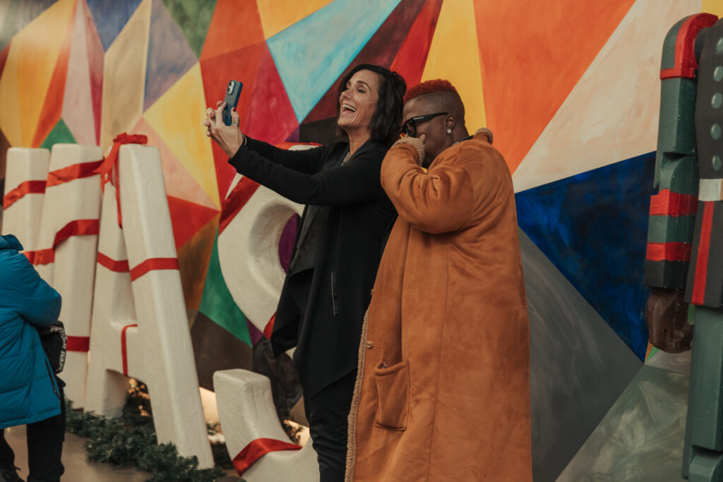 two people posing, one holding a camera for a self captured photo